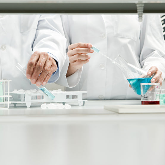Scientists creating heliocare sunscreen in the lab with fernblock extract for skin health