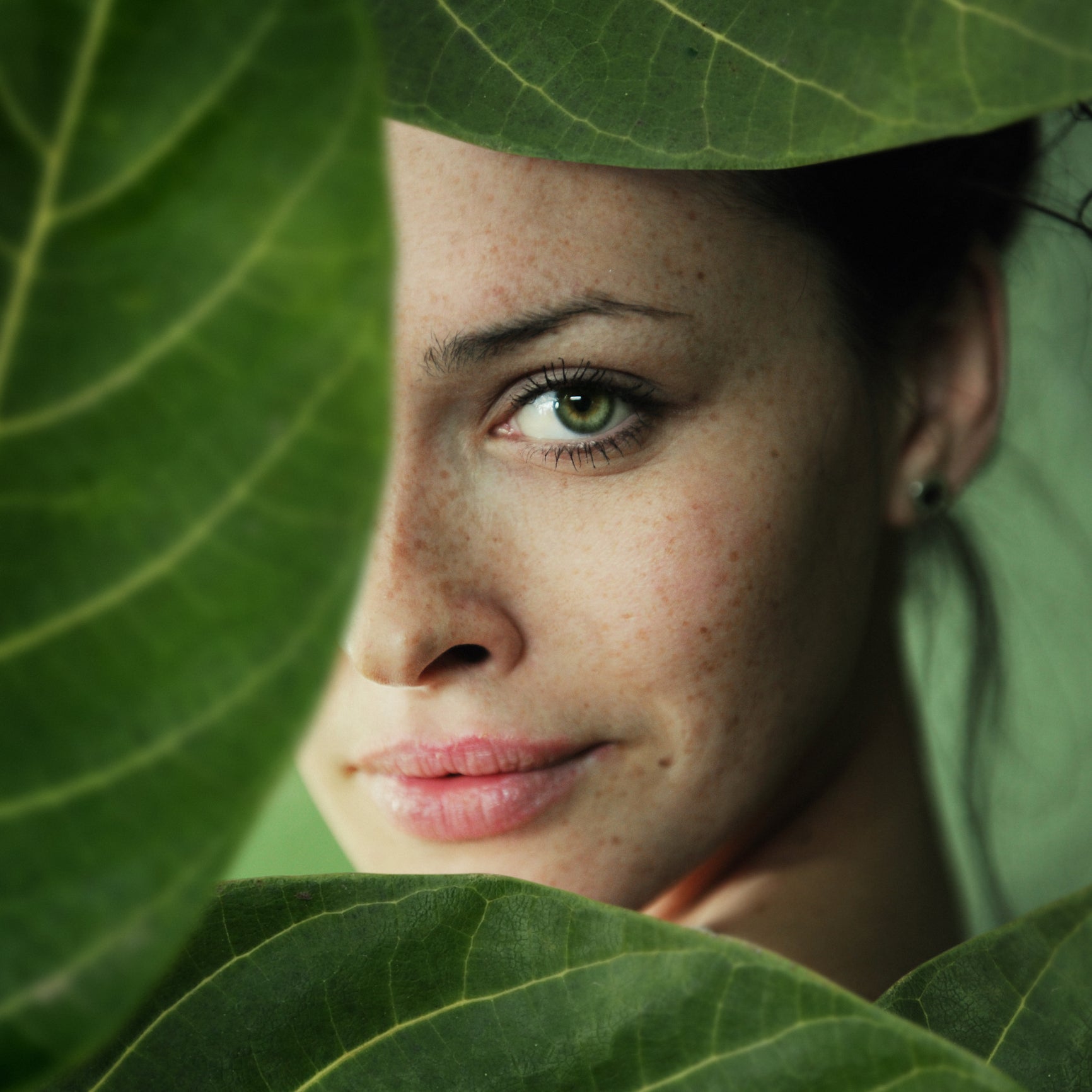 Lady hides in nature with Heliocare antioxidants for sun protection from within using fernblock supplements capsules